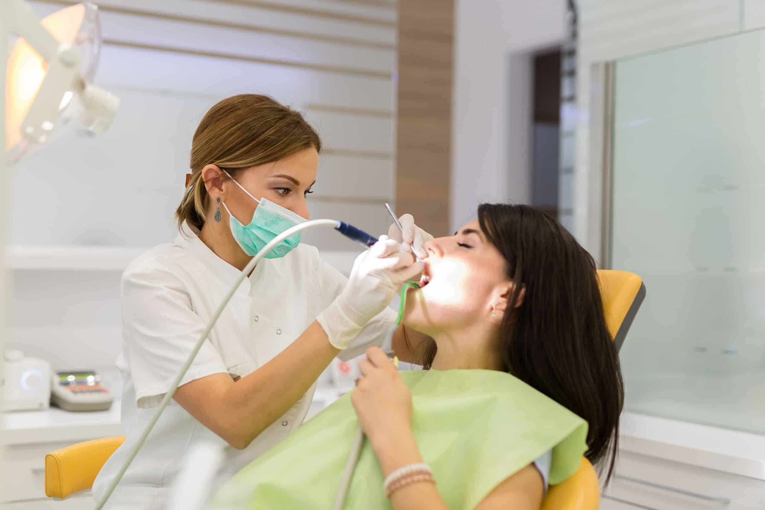 Dentist examining a patient for gum disease treatment in a Toronto dental clinic